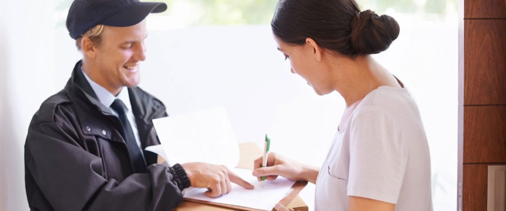 Courier collecting a signature on delivery